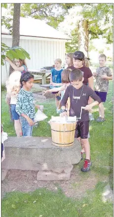  ?? (Courtesy Photo) ?? As they did during a previous event, young volunteers will help make ice cream Saturday for a virtual program at the Shiloh Museum of Ozark History. It will air live on Facebook.