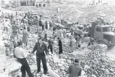  ?? ?? Residents clear rubble in Dresden; it was said today in 1945 that the city had been ‘wiped off the map’ by allied bombings