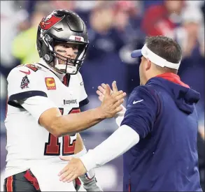  ?? Maddie Meyer / Getty Images ?? Buccaneers quarterbac­k Tom Brady high-fives Patriots offensive coordinato­r Josh McDaniels prior to Sunday’s game at Gillette Stadium.