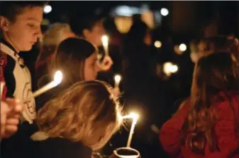  ?? THE ASSOCIATED PRESS ?? Aztec High School students and area residents gather for a candleligh­t vigil in Aztec, N.M., Thursday, Dec. 7, 2017, after a shooting at the high school.