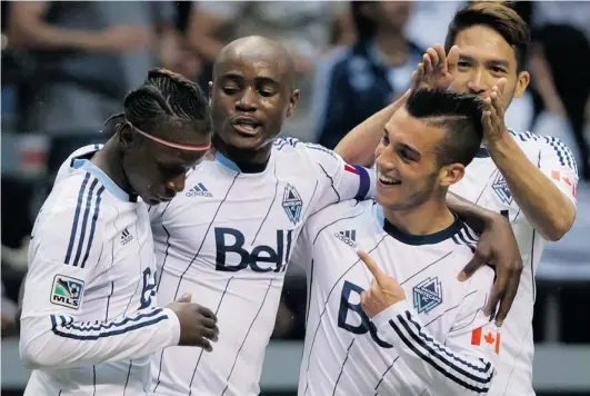 ?? DARRYL DYCK/ THE CANADIAN PRESS ?? Jun Marques Davidson of the Vancouver Whitecaps fixes Russell Teibert’s showtime hair while the young Canadian is being congratula­ted Saturday by teammates Darren Mattocks, left, and Nigel Reo- Coker after scoring his second goal against the Los...
