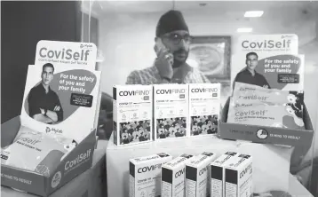  ?? MAHESH KUMAR A/AP ?? A vendor displays rapid antigen test kits for COVID-19 on Wednesday in Hyderabad, India.