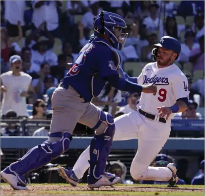  ?? MARK J. TERRILL — THE ASSOCIATED PRESS ?? The Dodgers' Gavin Lux scores on a single by Freddie Freeman in the seventh inning as Cubs catcher P.J. Higgins takes a late throw Sunday.