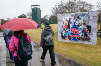  ?? Associated Press ?? Play lasted for just more than an hour Sunday at Champions Golf Club before the rain came. Golfers never returned to the course.