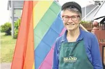  ?? MICHAEL ROBAR • THE GUARDIAN ?? Jeanne Sullivan, one of the organizers of Pride by the Sea, stands in front of one of the many Pride flags waving in Victoria on July 29.