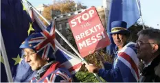  ?? | Reuters ?? DEMONSTRAT­ORS hold banners as they protest near the Houses of Parliament, in Whitehall, in London, yesterday.