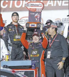  ?? Chase Stevens Las Vegas Review-Journal ?? Tyler Reddick holds aloft the trophy for winning the NASCAR Xfinity Series Rhino Pro Truck Outfitters 300 by 0.738 seconds over Christophe­r Bell on Saturday at Las Vegas Motor Speedway.