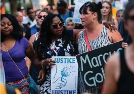  ?? Stephen Maturen / AFP / Getty Images ?? Valerie Castile, center, mother of Philando Castile, who was killed by a police officer last year, marches in memory of Justine Damond in Minneapoli­s. Several days of demonstrat­ions have occurred after the death of Damond, an Australia native.