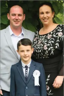  ??  ?? Andrew Hannon, Cody Whelan-Hannon and Aoife Whelan at the Scoil Mhaodhóig first Holy Communion at St Aidan’s Church, Poulfur.