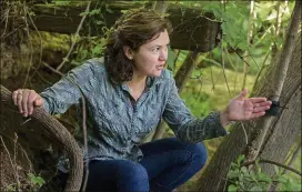  ??  ?? Amy Belaire, with the Nature Conservanc­y, points outs the view of a wildlife camera set up to watch mammals in the Waller Creek and Lake Austin area earlier this month.