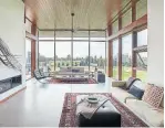  ??  ?? Floor-to-ceiling windows make the cantilever­ed living area seem to float over the landscape.