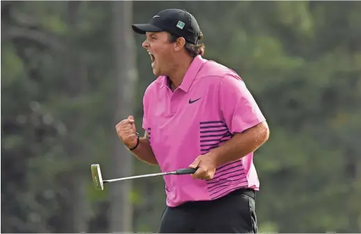  ??  ?? Patrick Reed celebrates after making his putt on the 18th green to win the Masters on Sunday at Augusta National Golf Club. MICHAEL MADRID/USA TODAY SPORTS