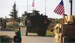  ??  ?? TIGHT VIGIL: A convoy of US forces armoured vehicles drives near the village of Yalanli, on the western outskirts of the northern Syrian city of Manbij. Photo - AFP file