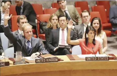  ?? MARY ALTAFFER — THE ASSOCIATED PRESS ?? Matthew Rycroft, British ambassador to the United Nations, and Nikki Haley , U.S. ambassador to the U.N., vote Saturday during a Security Council meeting on a new sanctions resolution to increase economic pressure on North Korea to make them return to...