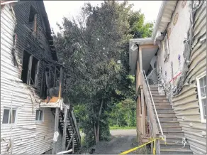  ?? ASHLEY THOMPSON ?? Firefighte­rs were able to prevent a blaze that broke out in an apartment on River Street in Kentville June 23 from spreading to other units and nearby buildings, including one that was close enough to sustain heat damage in the form of melted siding.