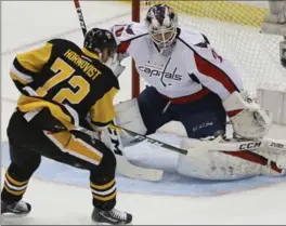  ?? GENE J. PUSKAR, THE ASSOCIATED PRESS ?? Penguins’ Patric Hornqvist scores past Washington Capitals goalie Braden Holtby in Pittsburgh on Wednesday night. Pittsburgh, minus Sidney Crosby due to a concussion, didn’t miss a beat, downing Washington, 3-2, to take a 3-1 lead in the Eastern Conference semifinal series.