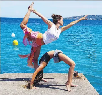  ?? THE ASSOCIATED PRESS/FILES ?? Brooke Burke-Charvet works out with her daughter, Rain, in Malibu, Calif.