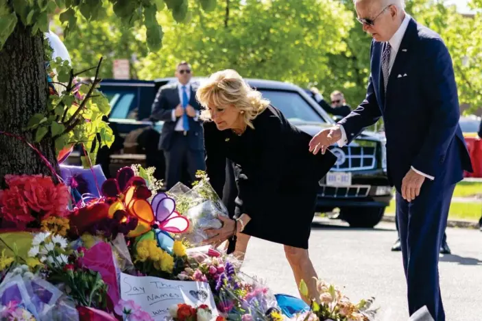  ?? Photograph: Andrew Harnik/AP ?? Joe Biden and the first lady, Jill Biden, pay their respects to the victims of Saturday’s shooting at a memorial across the street from the Tops Market in Buffalo.