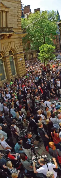  ??  ?? Remembranc­e: The crowds gathered in St Ann’s Square, Manchester, for a minute’s silence to honour the victims. They then spontaneou­sly started singing the Oasis song Don’t Look Back In Anger