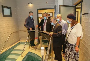  ?? ( Gershon Elinson/ Flash90) ?? RELIGIOUS SERVICES Minister Ya’akov Avitan ( second from left) tours a new mikveh in Efrat in August.