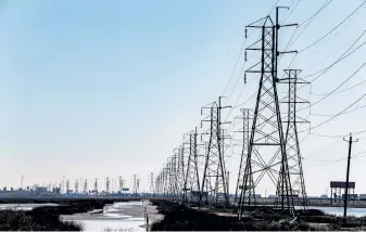  ?? Thomas Shea, AFP/Getty Images ?? Power lines in Texas City, Texas. Temperatur­es were expected to rise into the 50s across the Lone Star State after bone-chilling cold left millions without power and water last week.