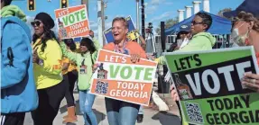  ?? BEN GRAY/AP ?? A rally Sunday in Atlanta draws a crowd during early voting for the Senate runoff election between Sen. Raphael Warnock, D-Ga., and Herschel Walker.