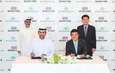  ?? WAM ?? Khaldoon Khalifa Al Mubarak, Managing Director and Group CEO of Mubadala, and Travis Kang, CEO of Nexen Tire, signed the MoU in Abu Dhabi on Thursday.