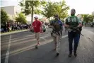  ??  ?? Armed counter-protesters in Hawaiian shirts, suggestive of an affiliatio­n with the boogaloo movement (a loosely organized far-right anti-government group) in Provo. Photograph: Steven Waggoner