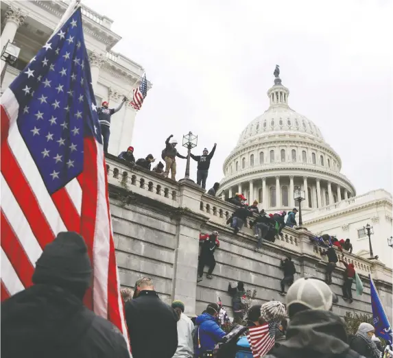  ?? JIM URQUHART /REUTERS ?? Donald Trump supporters climb walls at the U.S. Capitol during a protest against the certificat­ion of 2020's election results.