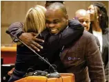  ?? CONTRIBUTE­D BY CHRISTINA MATACOTTA ?? Basil Eleby hugs Judge Rebecca Crumrine Rieder at Fulton County’s Accountabi­lity Court transition program graduation Friday.