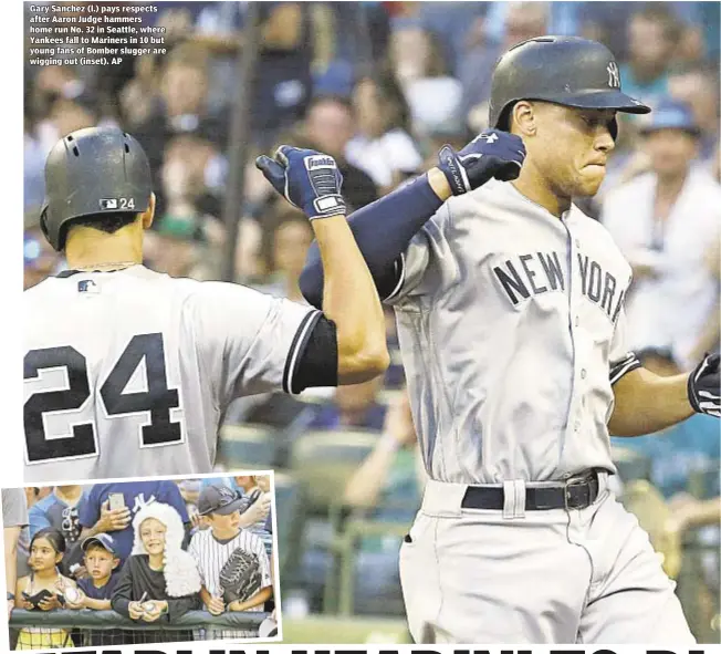  ??  ?? Gary Sanchez (l.) pays respects after Aaron Judge hammers home run No. 32 in Seattle, where Yankees fall to Mariners in 10 but young fans of Bomber slugger are wigging out (inset). AP
