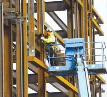  ?? The Canadian Press ?? A steel worker works on a new building in Ottawa. Statistics Canada says good jobs like this are growing in Canada.