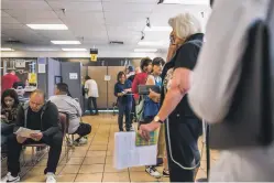  ?? NEW MEXICAN FILE PHOTOS ?? LEFT: Residents wait in line in April at a Motor Vehicle Division office in Albuquerqu­e. Stricter requiremen­ts imposed by the state have been a headache for many New Mexicans.