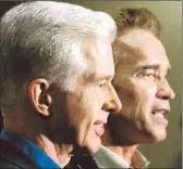  ?? Genaro Molina
Los Angeles Times ?? THE REPLACEMEN­T of Gray Davis, left, with Gov. Arnold Schwarzene­gger capped a political spectacle that was watched around the world.