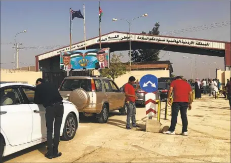  ?? Omar Akour Associated Press ?? A LINE of cars in Jordan waits to cross into Syria through the Nassib border gate, which opened Monday for the first time since 2015.