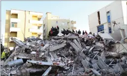  ?? Tribune News Service ?? Emergency workers look for survivors trough the rubble of a damaged building in the coastal city of Durres, west of capital Tirana, after an earthquake hit Albania, on Tuesday.