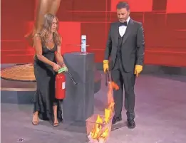  ??  ?? Jennifer Aniston and Jimmy Kimmel “sanitize” the envelope while presenting the outstandin­g lead actress in a comedy series award.