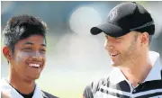  ?? /Getty Images ?? Mentor: Michael Clarke, right, invited Sandeep Lamichhane of Nepal to play club cricket in Australia.