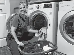  ?? CONTRIBUTE­D ?? After recovering from acute back pain, Laura Lundquist is (happily?) back to doing the laundry.