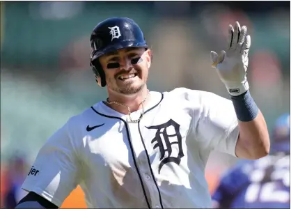  ?? PHOTOS BY CARLOS OSORIO — THE ASSOCIATED PRESS ?? Detroit Tigers’ Zach McKinstry crosses home plate to score during the sixth inning of a baseball game against the Texas Rangers, Tuesday, in Detroit.