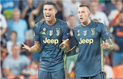  ?? AFP ?? Cristiano Ronaldo (left) reacts next to his teammates Federico Bernardesc­hi after receiving a red card during the Champions League match against AS Roma. —