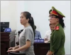  ?? ASSOCIATED PRESS ?? Prominent blogger Nguyen Ngoc Nhu Quynh, left, stands trial in the south central province of Khanh Hoa, Vietnam, Thursday. was sentenced Thursday to 10 years in prison after being found guilty of distorting government policies and defaming the...
