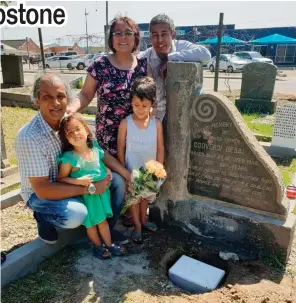  ??  ?? Desmond Desai with family members at the new site where the tombstone has been moved.