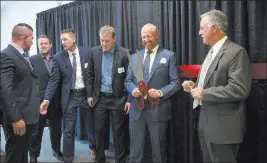  ?? Caroline Brehman ?? Las Vegas Review-journal Jeff Iverson, second from right, founder of Crossroads of Southern Nevada, gets ready for Thursday’s ribbon-cutting ceremony at its facility in Las Vegas.