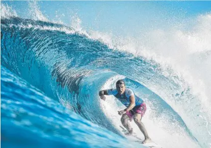  ?? SWALLOWED UP: Queensland surfer Julian Wilson negotiates a wave at the Billabong Pipe Masters in Hawaii. ??