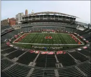  ?? THE ASSOCIATED PRESS ?? Players walk out to the field on Sept. 13, at Paul Brown stadium that is devoid of fans to start warming up before an NFL football game between the Cincinnati Bengals and the Los Angeles Chargers, in Cincinnati. About one in six Ohio school districts asked the state for permission to add additional spectators for fall sporting events, exceeding the limits set by Gov. Mike DeWine in last month’s sports order, records show.