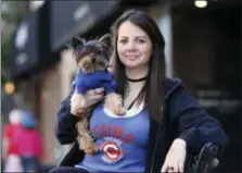  ?? ASSOCIATED PRESS ?? Lauren Pestikas holds her dog Sambuca in Chicago. Since starting treatments with ketamine infusions, she says she feels much better for a few weeks after each session. Her monthly infusions last about 45 minutes and cost $550 each.
