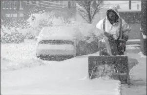  ?? The Associated Press ?? VIRGINIA: Residents try to keep ahead of the snow with the aid of a snowblower Sunday in Roanoke, Va.