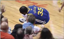  ?? [FRANK GUNN/ THE CANADIAN PRESS VIA AP] ?? Warriors forward Kevin Durant goes down with a leg injury in the first half of a 106-105 win against the Raptors in Game 5 of the NBA Finals on Monday in Toronto.