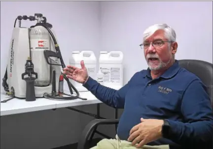  ?? PETE BANNAN-DIGITAL FIRST MEDIA ?? Mold N’ More Decontamin­ation Inc.’s Bill Young displays a backpack applicatio­n system that sprays firefighte­rs with foam after they exit hazardous areas.